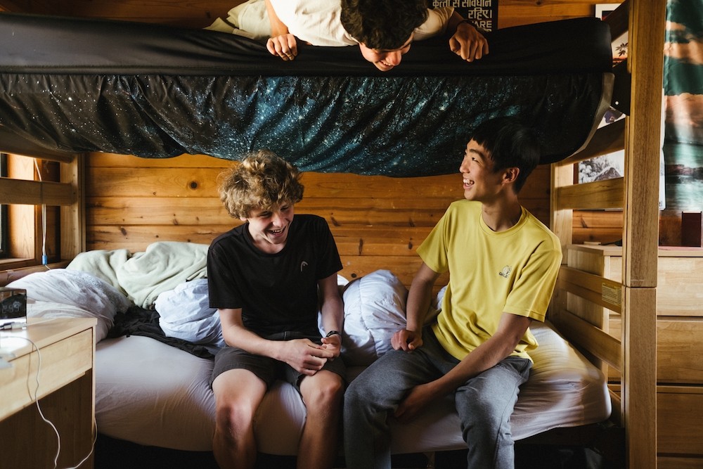 students hang out in cabin