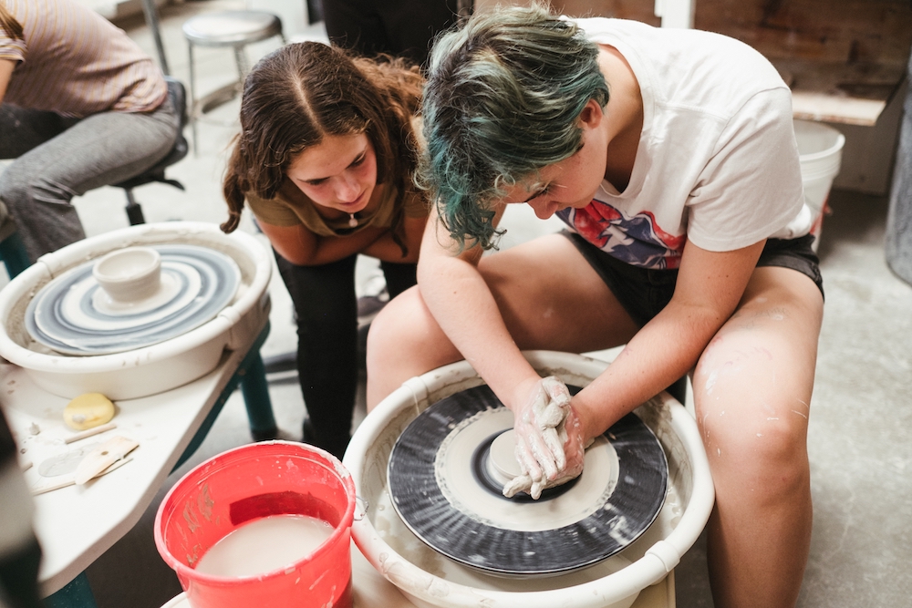 students at ceramics wheel